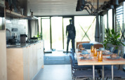 Moderne keuken en eetruimte in Sea Lodges Zandvoort 6 strandhuis, tafel gedekt en glazen wanden.