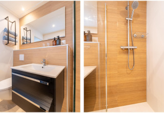 Modern bathroom at the lodge 'By the Baker' in the Netherlands, with a vanity sink and wood-look shower area.