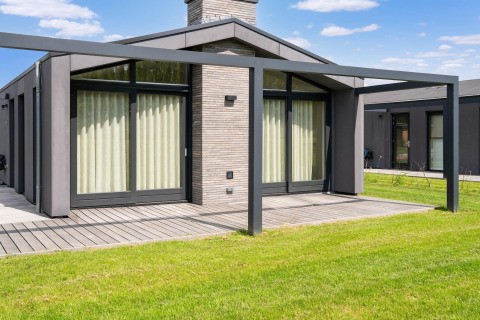 Vue extérieure d’une maison de vacances moderne avec grandes fenêtres et terrasse près des lacs Kaag, Pays-Bas.