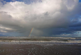View of the sea with clouds and a rainbow, taken from the cabin 'De Schone Leij' in the Netherlands.