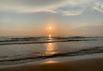 Sunset over the sea with gentle waves on the beach, taken from the cabin 'De Schone Leij' in the Netherlands.