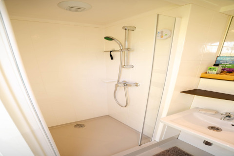 Moderne Dusche mit Handbrause in einem kleinen, hellen Badezimmer eines Apartments nahe der Küste in den Niederlanden.