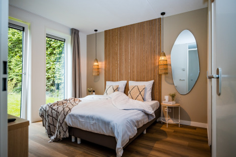 Camera moderna in casa vacanze vicino alla foresta a Voorthuizen, Paesi Bassi, con letto matrimoniale.