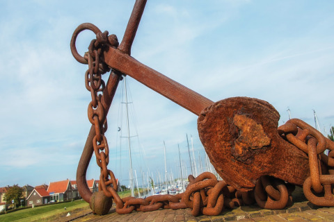 Grande ancora arrugginita con catena vicino a un porto turistico al Water Resort Oosterschelde 13, Paesi Bassi.