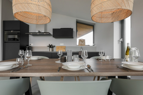 Moderne spisestue og køkken i Heerlijkheid Vlietenburg 1, med elegant borddækning og varm belysning.
