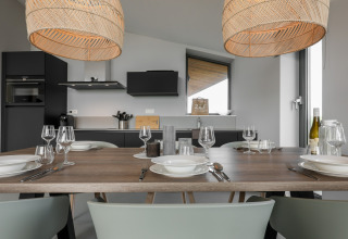 Moderne spisestue og køkken i Heerlijkheid Vlietenburg 1, med elegant borddækning og varm belysning.