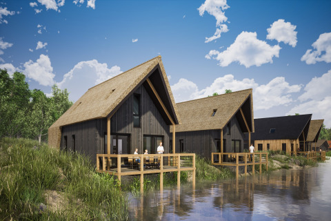 Lodge con tetto in paglia sul lungolago al Resort Nieuwvliet-Bad 13 sotto un cielo azzurro parzialmente nuvoloso.