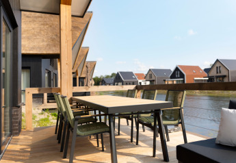 Outdoor terrace at Resort Nieuwvliet-Bad 13 in the Netherlands featuring dining set and water view.