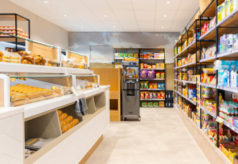 A modern store at Resort Nieuwvliet-Bad 13 in the Netherlands featuring fresh bread and stocked shelves.