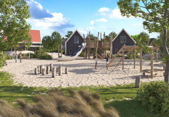 Sandy outdoor playground with wooden structures and slide, children playing, cabins and trees in background.