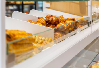 Bakery display case with fresh croissants and pastries at Resort Nieuwvliet-Bad 13 in the Netherlands.