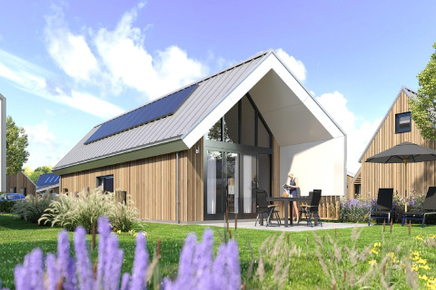 Lodge moderne au Holiday Park Zeebad 14 aux Pays-Bas, avec panneaux solaires et jardin sous ciel bleu.