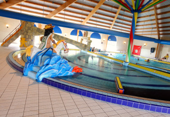 Indoor swimming pool at Holiday Park Zeebad in the Netherlands featuring colorful water slides and decor.