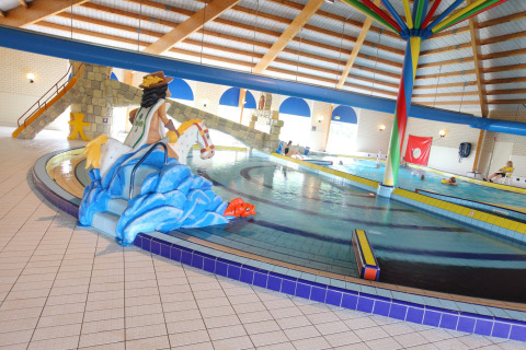 Piscina coperta presso Holiday Park Zeebad nei Paesi Bassi con scivoli e decorazioni colorate.