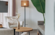 Modern lounge at Holiday Park Zeebad 12, Netherlands, featuring cozy armchairs, a lamp, and elegant decor.