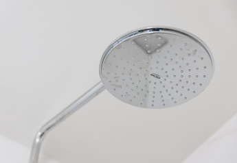 Modern showerhead at Holiday Park «Zeebad 12» in the Netherlands, close-up of chrome fixture.