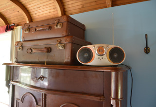 Zwei Vintage-Koffer und ein Radio auf einem Schrank in der Pipowagen 'de Weideblick', Niederlande.
