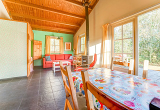 Bright living area at Holiday Home «5 Aarde Green Camping Lage Zwaluwe» in the Netherlands, with wooden ceiling.