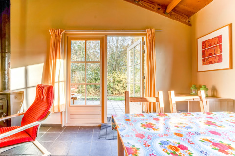 Helles Wohnzimmer mit offener Terrassentür im Holiday Home 5 Aarde Green Camping Lage Zwaluwe, Niederlande.