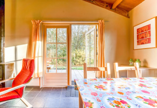 Lyst interiør med åbne døre til terrasse i Holiday Home 5 Aarde Green Camping Lage Zwaluwe i Holland.