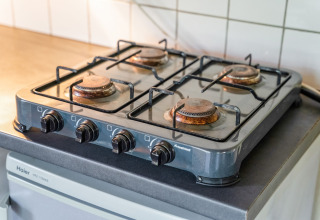 Four-burner gas stove in the kitchen area of Holiday Home 5 Aarde Green Camping Lage Zwaluwe, Netherlands.