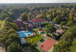 Aerial view of Park Duc de Brabant 3 in the Netherlands showing pool, tennis court, chalets and greenery.