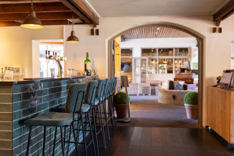 Modern bar with stylish high chairs in Park «Duc de Brabant 3» chalet in the Netherlands.