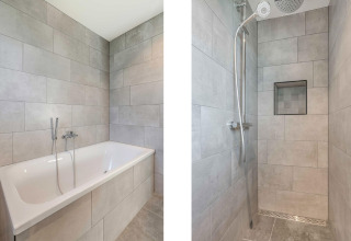 Moderne badeværelsesdesign med separat badekar og brusekabine på Park de Kievit 22-lodge i Belgien.