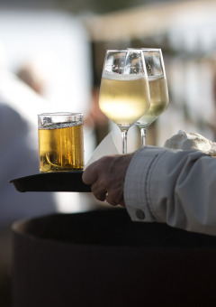 Tray with two glasses of white wine and other drink