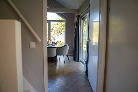 Entrance to a dining area with large windows and modern furniture at Holiday Park «Latour 4» in the Netherlands.