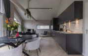 Alojamiento moderno en Holiday Park «Latour 6», Países Bajos, con cocina negra y zona de comedor elegante.