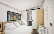 Chambre moderne avec lit double, lit bébé et porte coulissante vers la salle de bain à Holiday Park Klein Vink 25.