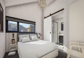 Chambre moderne au Holiday Park «Klein Vink 24» aux Pays-Bas avec lit double et salle de bain attenante.