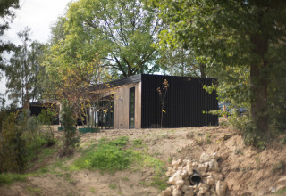 Modern lodge at Resort Gulpen 2 in the Netherlands, surrounded by greenery and natural landscape.