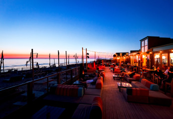 Vue au coucher du soleil depuis Sea Lodges «Bloemendaal 3» aux Pays-Bas, avec salons extérieurs confortables.
