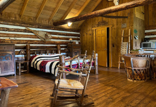 Gemütliche Einrichtung der American Log Cabin Chalet in den Niederlanden mit Holzmöbeln und rustikaler Atmosphäre.
