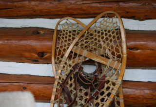 Traditionelle Holzschneeschuhe an einer Blockhüttenwand im American Log Cabin, Niederlande.