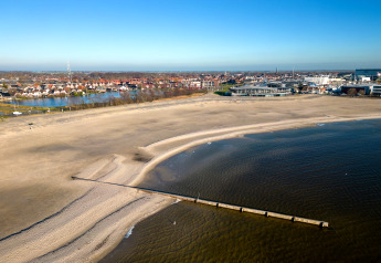 Beach and sea view from Houseboat «Refugio» in the Netherlands, with city buildings in the background.