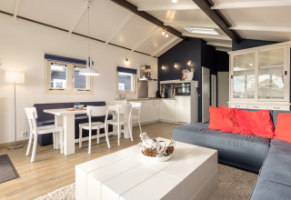 Bright, modern chalet interior at Water park «Terkaple 2» in the Netherlands featuring a cozy living space.