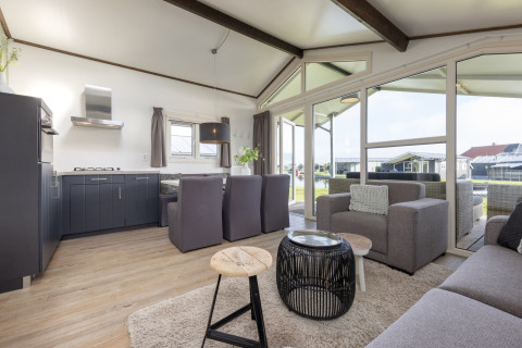 Modernes, lichtdurchflutetes Wohnzimmer im Chalet Water park Terkaple 1 in den Niederlanden mit schönen Möbeln.