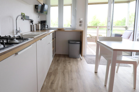 Modern kitchen and dining area in the 'Terrace lodge 2' chalet in the Netherlands, with terrace view.