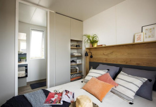 Modern bedroom at chalet 'Terrace lodge 2' in the Netherlands with stylish decor and natural lighting.