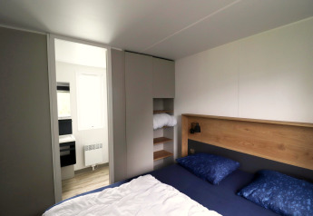 Bedroom in Terrace Lodge 2 chalet in the Netherlands with double bed, modern storage, and access to bathroom.