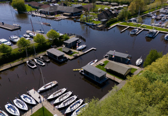 Vista aérea de la Safari Tent Heeg para 4 personas, junto a un muelle y barcos en los Países Bajos.