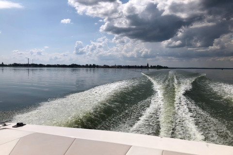 View from a boat on the lake near Holiday home Inselblick in Nowe Warpno, Germany, with clouds above.