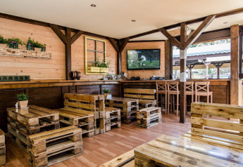 Interior view of Holiday cottages Łazy in Denmark, featuring pallet furniture and wooden decor.