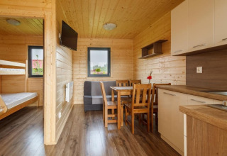 Binnenzicht van een vakantiewoning in Gąski, Denemarken met houten muren, keuken en stapelbedden.