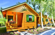 Summer cottages for 4 people in Mielno, Denmark, picturesque wooden lodges among trees and gardens.