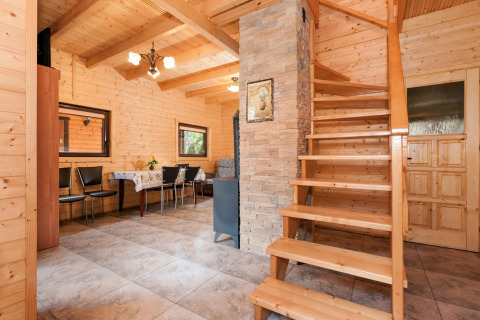 Interior of Holiday complex Pobierowo-Doppelhaus 4 and 2 featuring wood walls, staircase, and dining area.