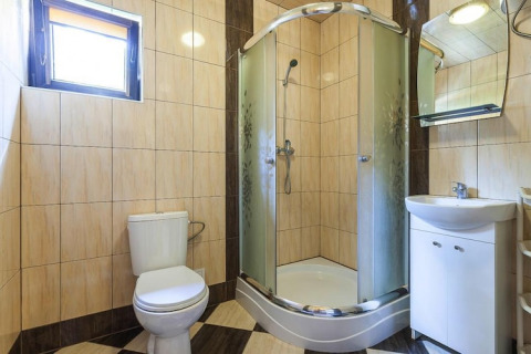 Bright bathroom with shower, toilet and sink at Holiday complex Pobierowo-Doppelhaus 4 and 2 in Germany.